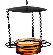 An orange glass bird feeder with black metal stand over a white background.